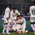 Milan beat nine-man Bologna to go top of Serie A