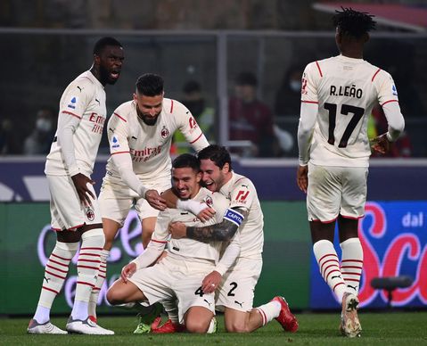 Milan beat nine-man Bologna to go top of Serie A