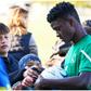 Nwankwo Kanu's Izuogu Chibueze with fans at the match.