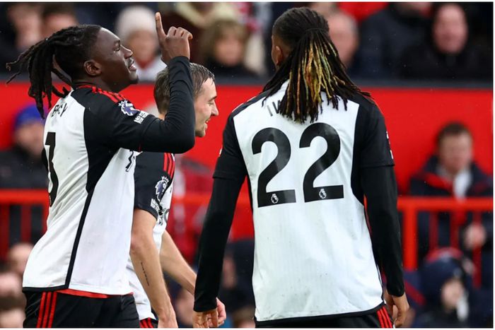 Calvin Bassey and Alex Iwobi celebrate at Old Trafford against Manchester United.