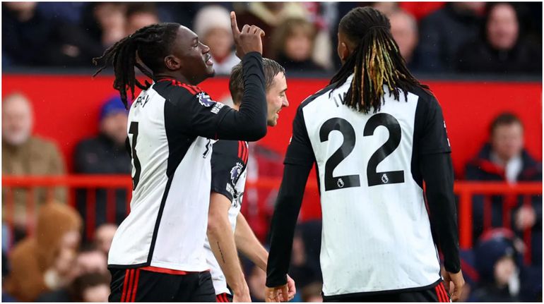 Calvin Bassey and Alex Iwobi celebrate at Old Trafford against Manchester United.