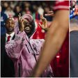 Injured Nottingham Forest defender Ola Aina dancing energetically in the tunnel after the 2-0 win over FC Porto, wearing a tracksuit and hugging teammate Morgan Gibbs-White.