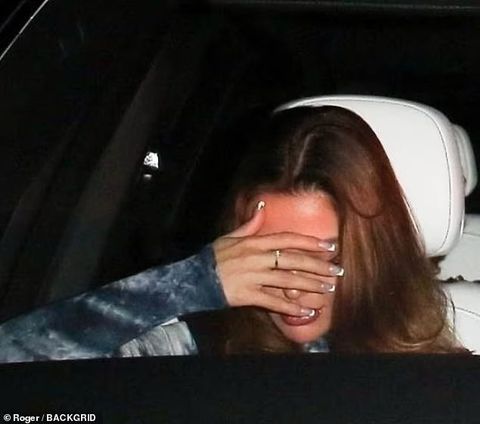 Ashlyn Castro shields her face from the cameras after being spotted with Hollywood star Jamie Foxx | BackGrid via DailyMail