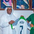 In Kano, Super Eagles captain Ahmed Musa gifts a Nigerian jersey to the Saudi Arabia Consul.