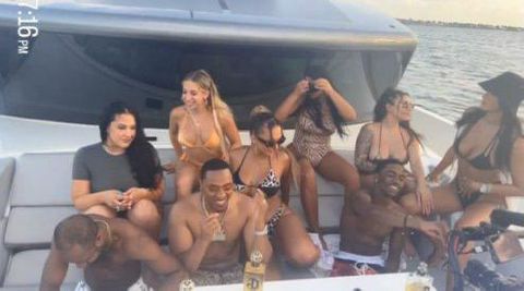 Ashlyn Castro at the far right in a bucket hat partying on yacht with friends and son of imprisoned mogul P Diddy
