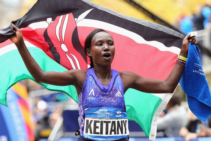 Mary Keitany flying the Kenyan flag in celebration.