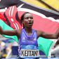 Mary Keitany flying the Kenyan flag in celebration.