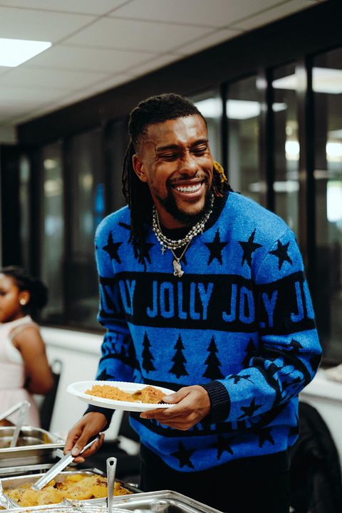 A happy Alex Iwobi with plate of food
