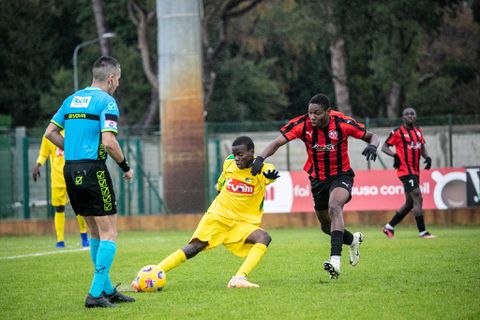 Flying Eagles invitee Kparobo Arierhi (red) contest the ball against Brazzaville.