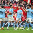 Manchester City players celebrate a goal.