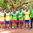 Meru County Chief Officer of Sports, Talent Development and Creative Arts Pithon Muchoki poses with a photo with KYISA Volleyball girls at a training camp.