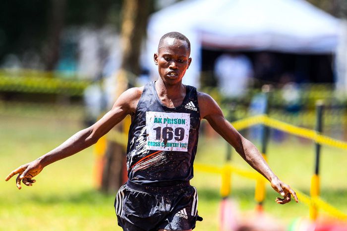 Isaiah Lasoi celebrates while crossing 10km senior men on December 17th during Athletics Kenya Prisons National Cross Country championship at Prisons Staff Training College.