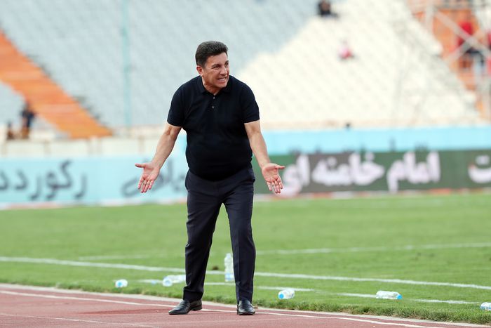 Iran coach on the touchline.