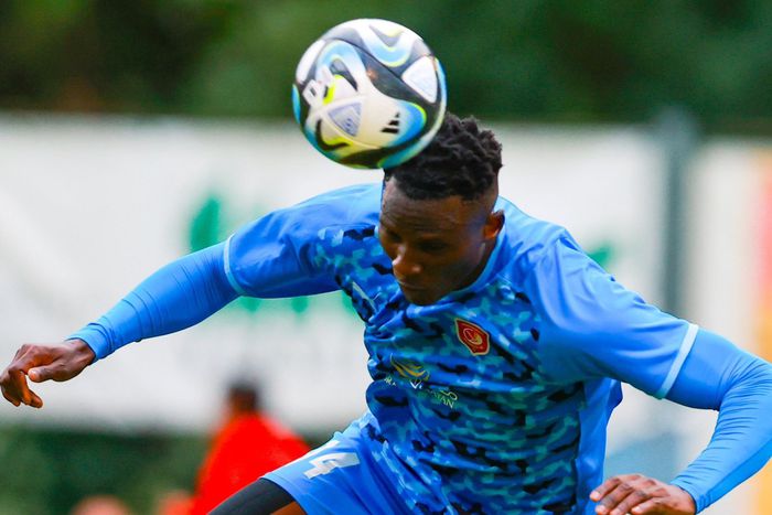 Michael Olunga heads the ball.