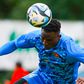 Michael Olunga heads the ball.