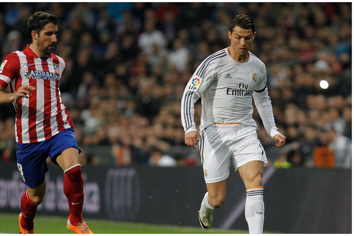 LaLiga legend Raul Garcia (left) marks Cristiano Ronaldo (right) during one of the Madrid derbies.