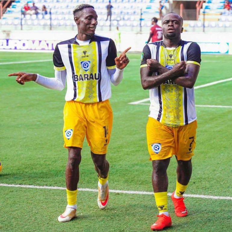 Joseph Atule (left) opened the scoring from the spot kick.