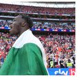 Elijah Adebayo celebrates with the Nigerian flag after the win.