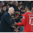 Manchester United's Erik Ten Hag gives instructions to Marcus Rashford during a game.