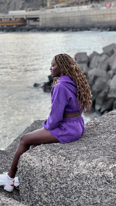 Super Falcons of Nigeria star Rinsola Babajide shows off style in purple outfit.