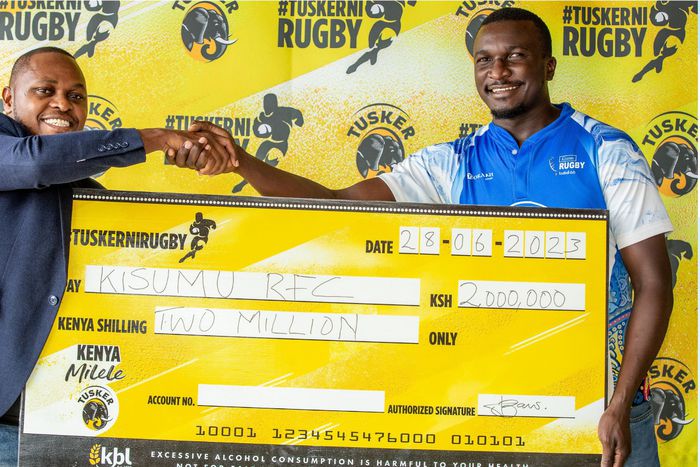 Tusker Brand Manager Lennox Mwalea presents the sponsorship to Kisumu RFC Vice Chairman Gabriel Ouma