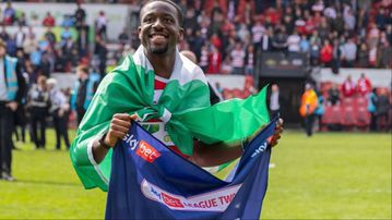 Joseph Olowu celebrates Doncaster Rovers promotion with Nigerian flag