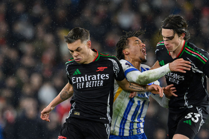 Joao Pedro of Brighton and Hove Albion is challenged by Leandro Trossard (L) and Riccardo Calafiori of Arsenal during the Premier League match at the AMEX Stadium, Brighton and Hove. Picture credit : Paul Terry