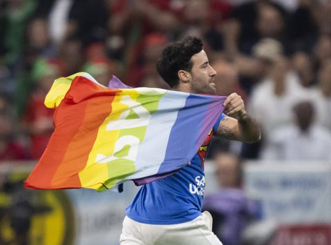 Pitch invader displays rainbow flag during the Portugal vs Uruguay match