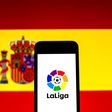September 16, 2021, Barcelona, Catalonia, Spain: In this photo illustration a LaLiga logo seen displayed on a smartphone with a Spanish flag in the background. Barcelona Spain -