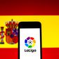 September 16, 2021, Barcelona, Catalonia, Spain: In this photo illustration a LaLiga logo seen displayed on a smartphone with a Spanish flag in the background. Barcelona Spain -