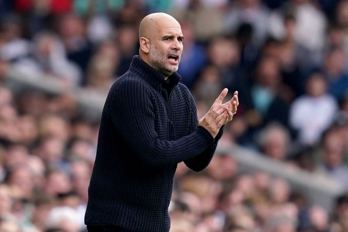 Pep Guardiola applauds Manchester City players after victory over Fulham.