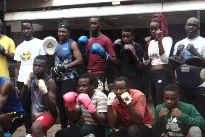 WKF of Kenya president Japheth Yahuma (second from the L, standing), poses for a photo with boxers.
