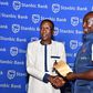 Mwenda wins Stanbic April mug at UGC as Kenyan ambassador Owinow signs out.