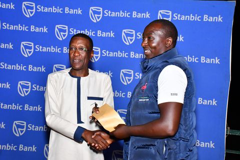 Mwenda wins Stanbic April mug at UGC as Kenyan ambassador Owinow signs out.