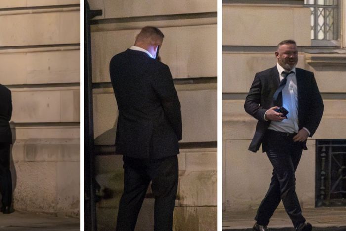 Wayne Rooney releiving himself against a wall.