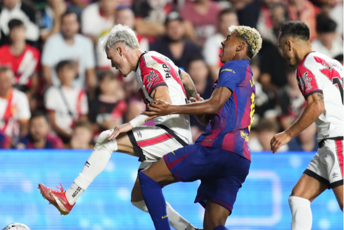 Pep Chavarria of Rayo Vallecano in action against Lamine Yamal of Barcelona during the La Liga EA Sports match between Rayo Vallecano de Madrid and FC Barcelona at Estadio de Vallecas || Image credit: Imago
