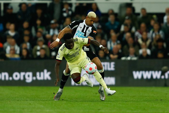 Newcastle United v Arsenal - Premier League Joelinton of Newcastle United and Bukayo Saka of Arsenal in action during the Premier League match between Newcastle United and Arsenal at St. James s Park