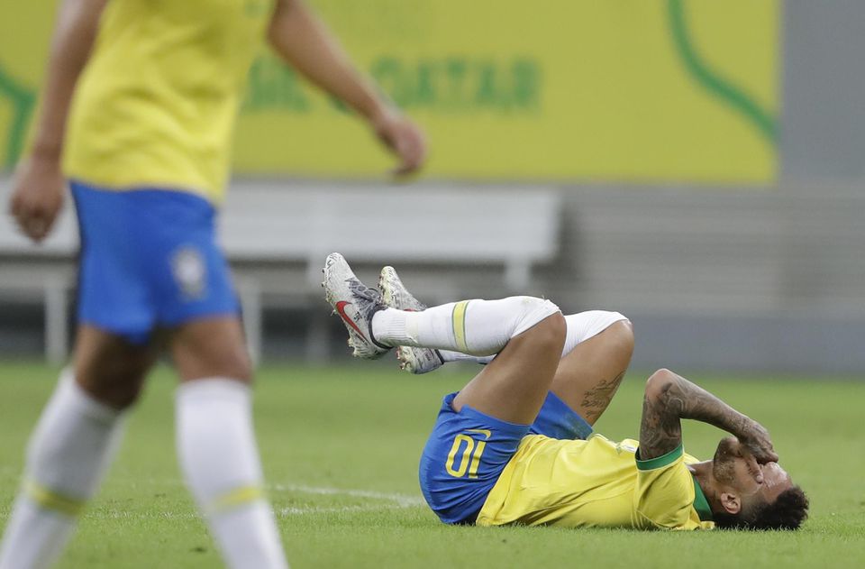 Brazílsky futbalový reprezentant Neymar leží na trávniku.
