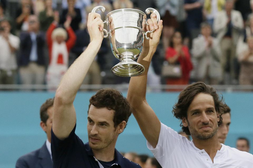 Britsko-španielsky pár Andy Murray (vľavo) a Feliciano Lopez pózujú s trofejou po zisku titulu vo štvorhre na turnaji v londýnskom Queen's Clube.