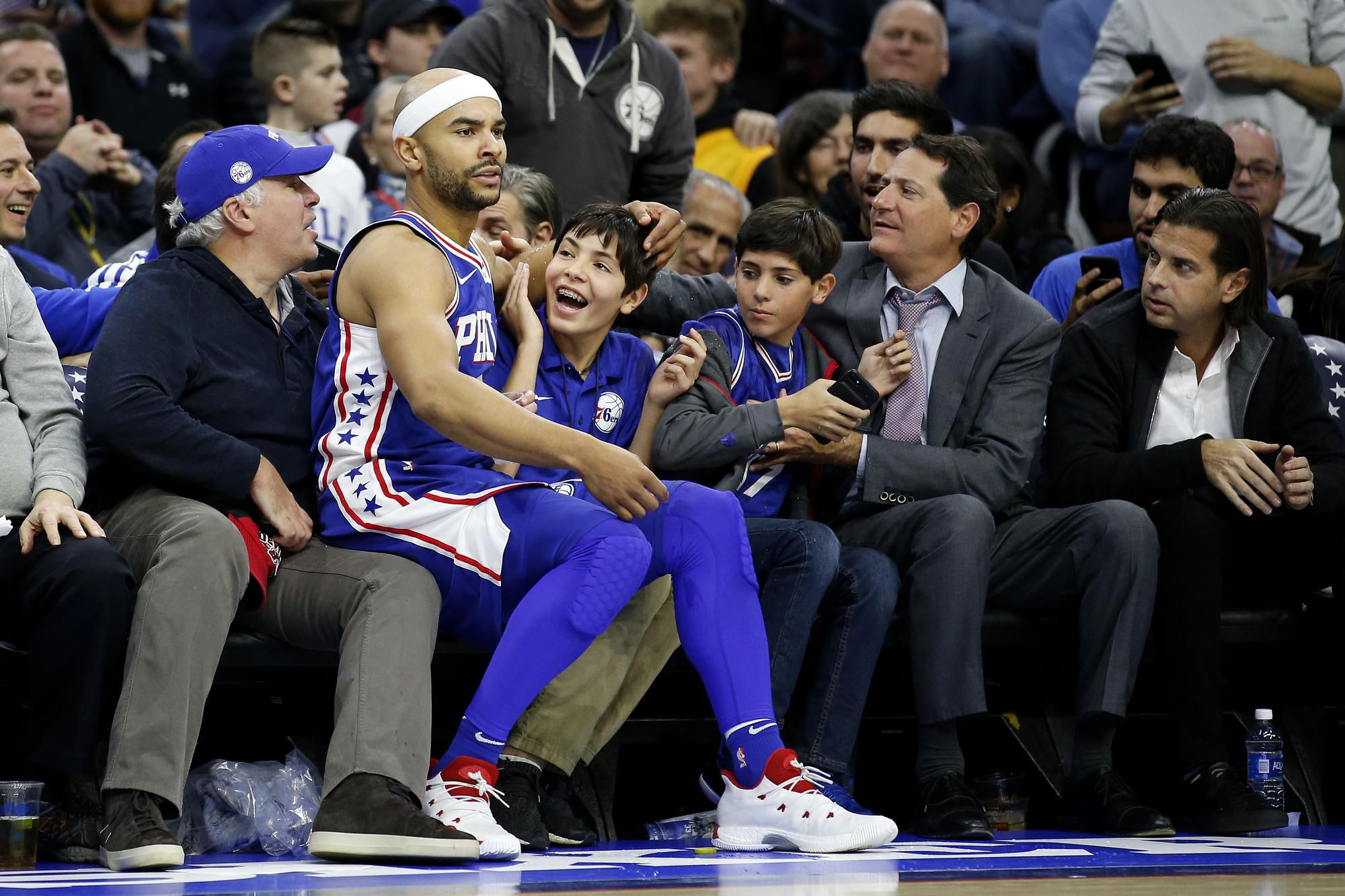 Jerryd Bayless sedí medzi fanúšikmi po tom, ako sa v jednom zo súbojov neudržal na ihrisku.