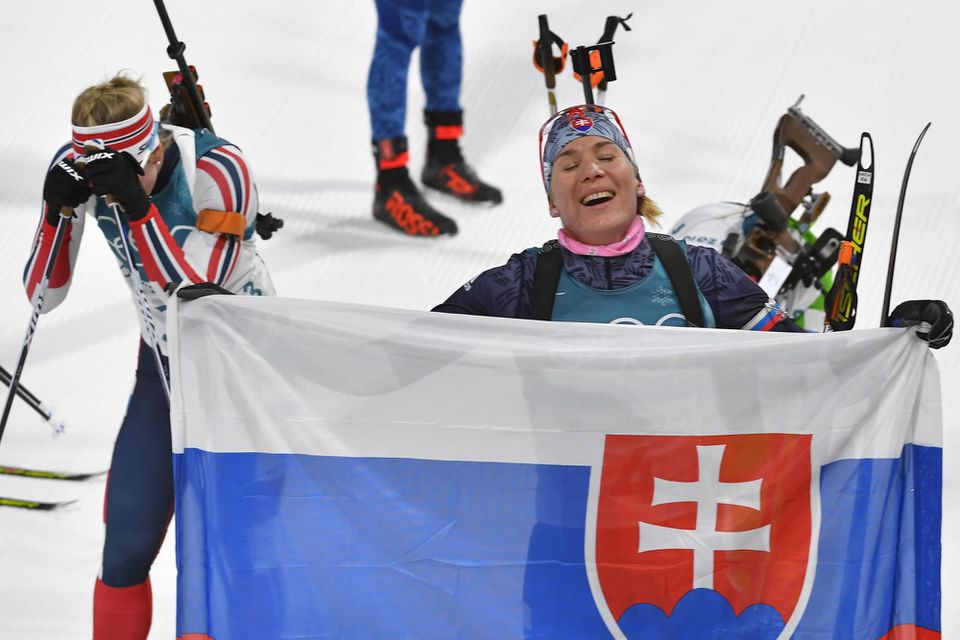 Anastasia Kuzminová drží slovenskú vlajku v cieli po zisku zlatej olympijskej medaily.