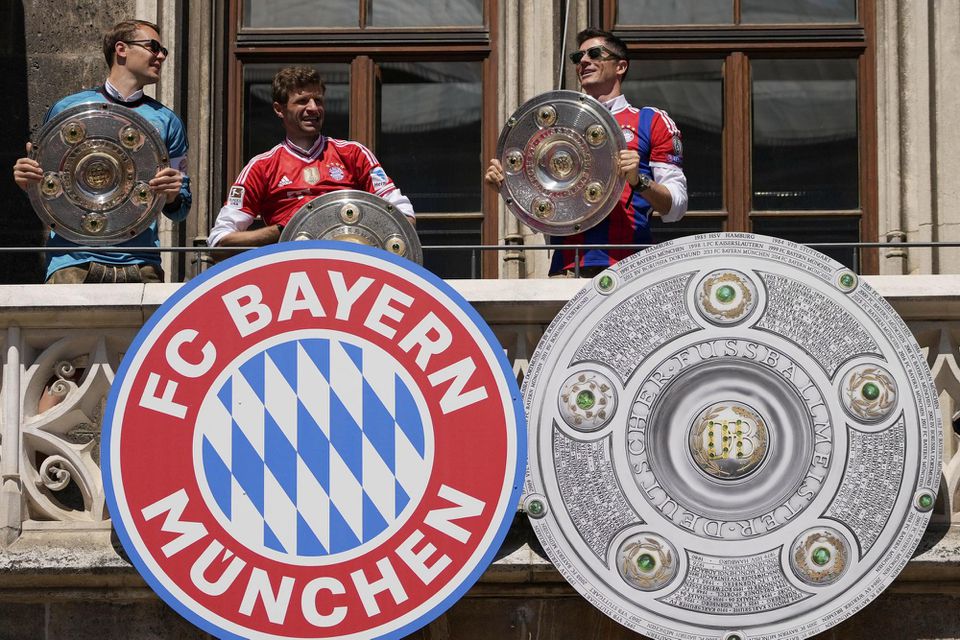 Futbalisti Bayernu Mníchov zľava Manuel Neuer, Thomas Müller a Robert Lewandowski pózujú s trofejou