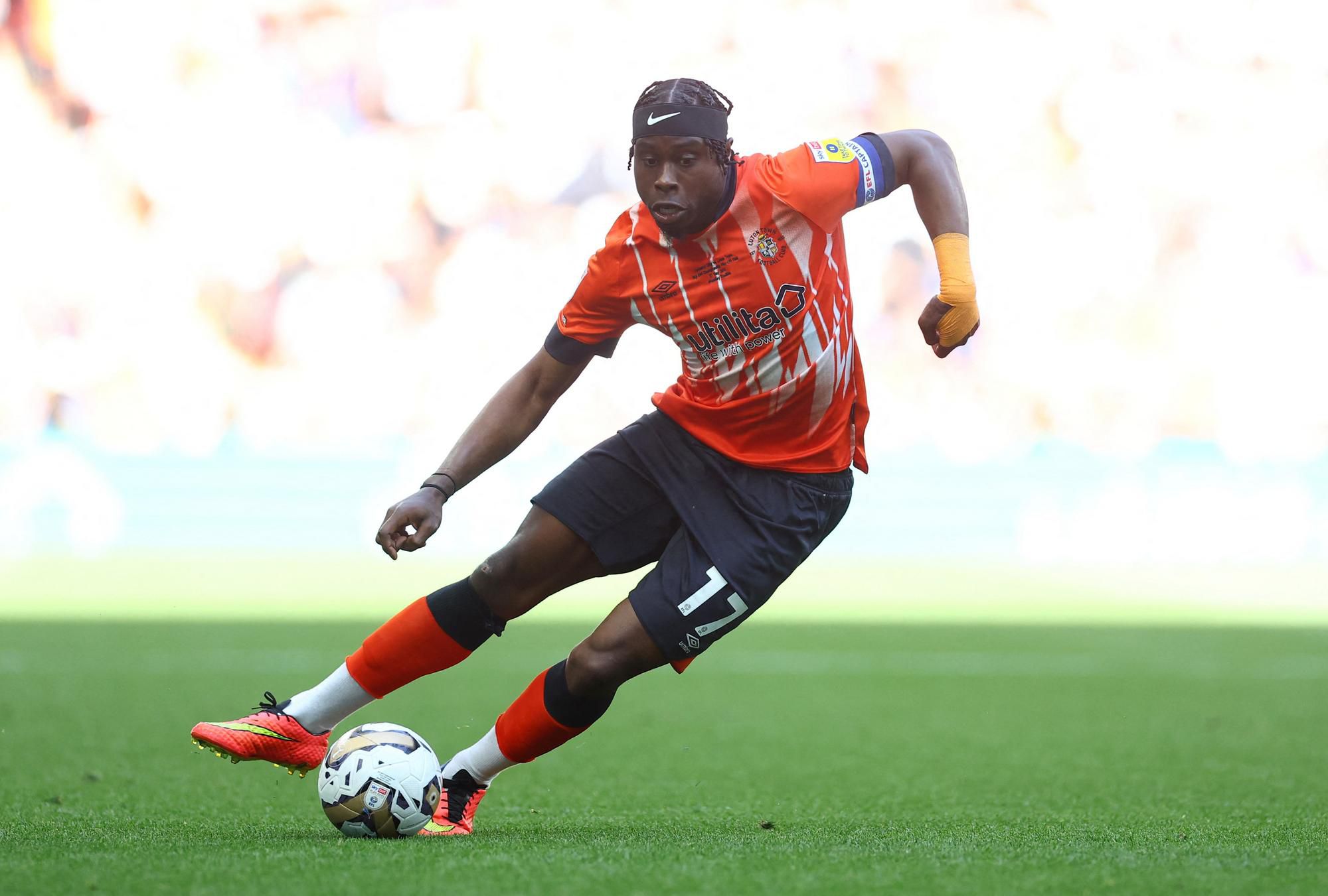 Pelly Ruddock Mpanzu (Luton Town FC) je prvý futbalista, ktorý postúpil z neligovej scény do Premier League s jediným klubom