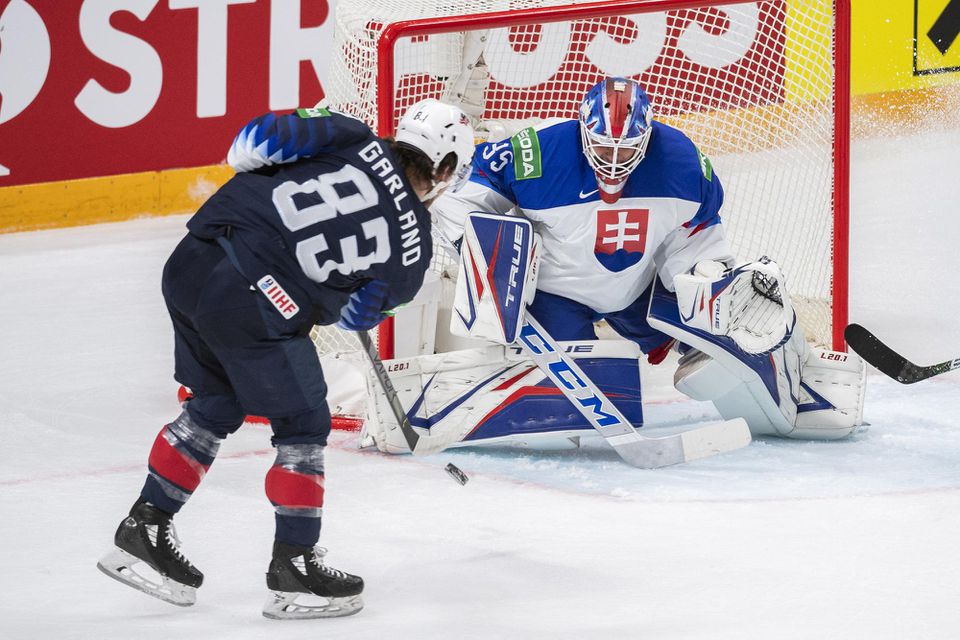 MS v hokeji 2021: USA - Slovensko: Conor Garland (USA) strieľa gól na 3:0 brankárovi Adamovi Húskovi (Slovensko)