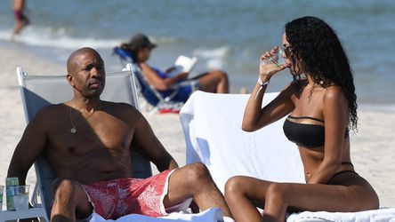 📸 | NBA-pensionada Kenny Smith (58) op het strand gespot met veel jonger model