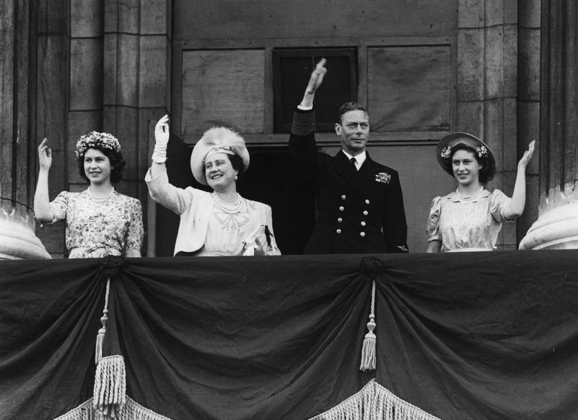Отляво надясно - принцеса Елизабет, кралица Елизабет Боуз-Лайън, крал Джордж VI и принцеса Маргарет Роуз махат от балкона на Бъкингамския дворец на 15 август 1945 г. в Лондон, Англия.